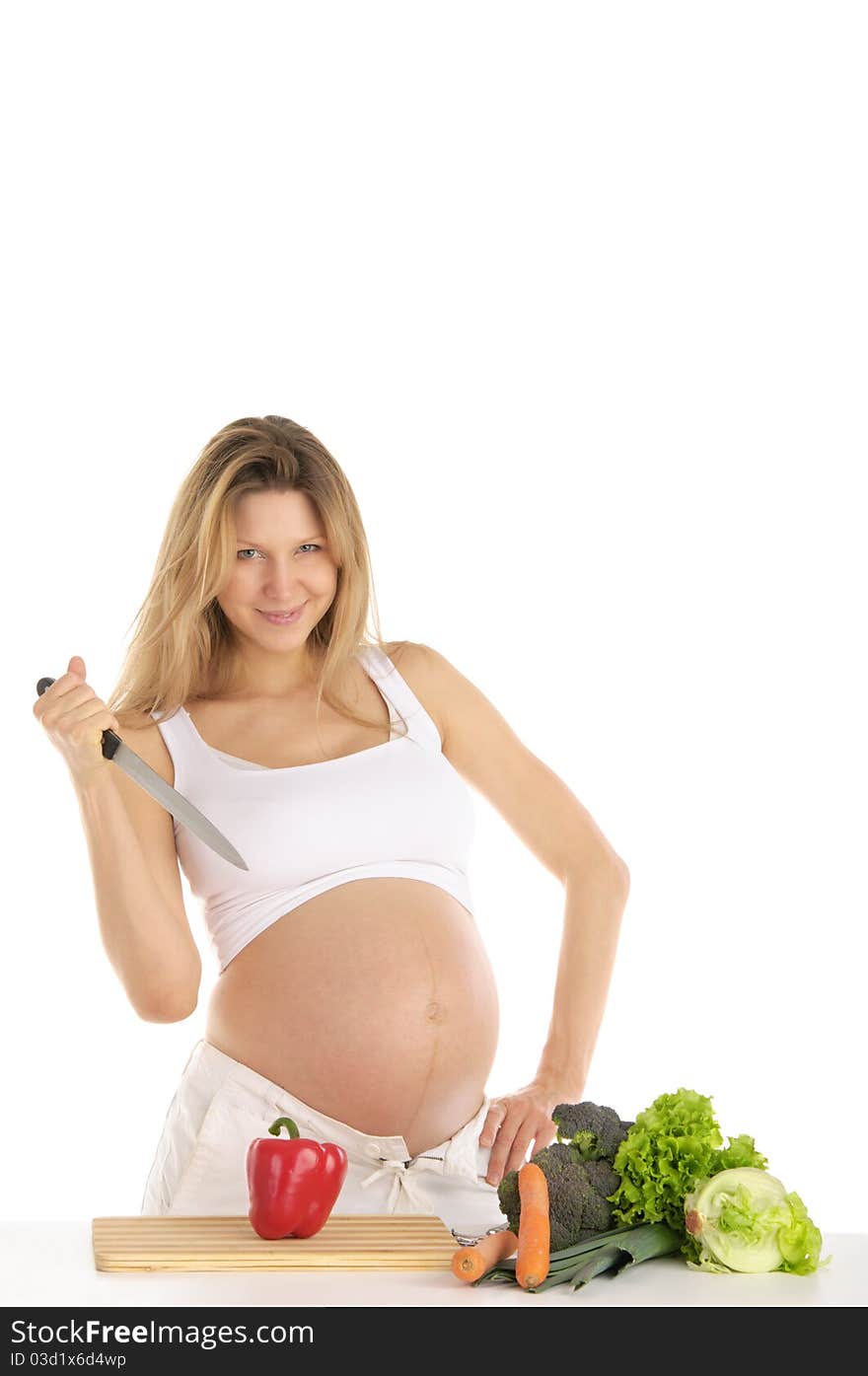 Pregnant woman with fruits, vegetables and knife isolated on white