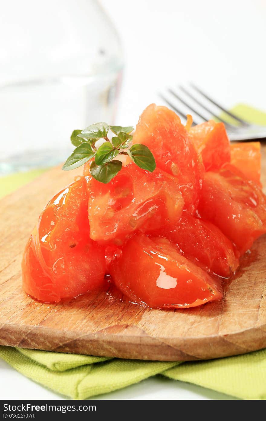 Tomatoes cut into sections on a cutting board