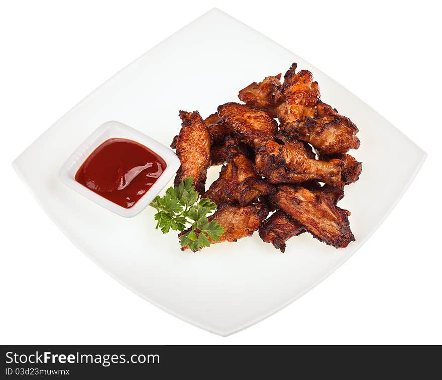 Roasted chicken thigh with sauce on a square plate isolated