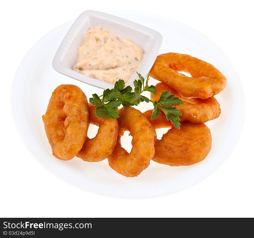 Fried squid rings with a cheese sauce isolated