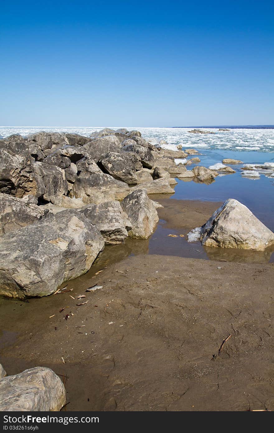 Several stone breakwall protecting a Lake Erie beach. Several stone breakwall protecting a Lake Erie beach