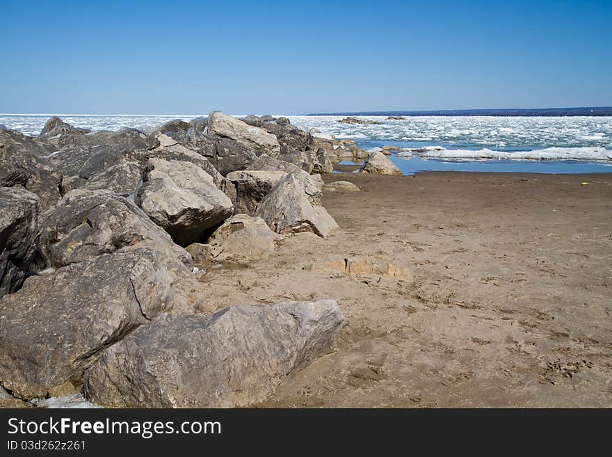 Several stone breakwall protecting a Lake Erie beach. Several stone breakwall protecting a Lake Erie beach