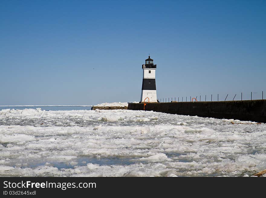 Lighthouse on Lake Erie at the end of a cement dock