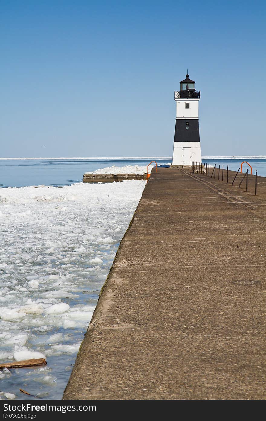 Lighthouse on Lake Erie at the end of a cement dock