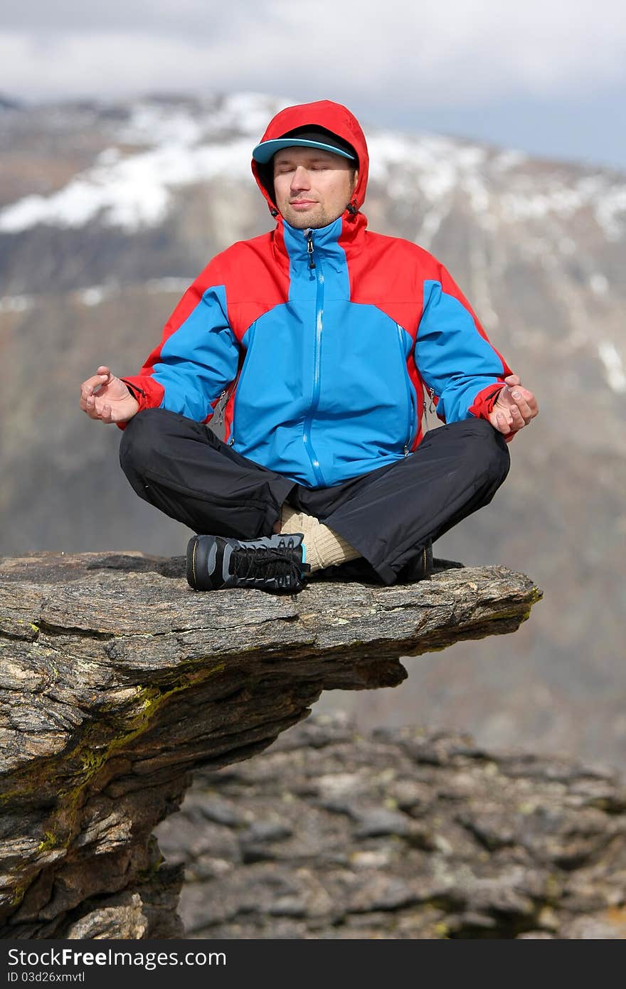 Yoga relax time on cliff in high mountains. Yoga relax time on cliff in high mountains