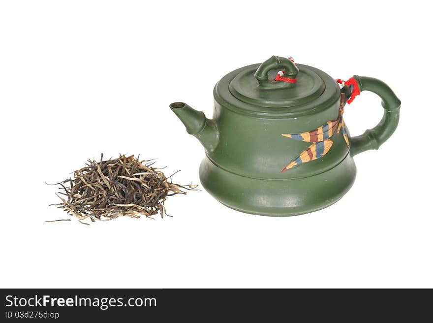 Green Chinese Teapot With Some Dry Tea Leaves