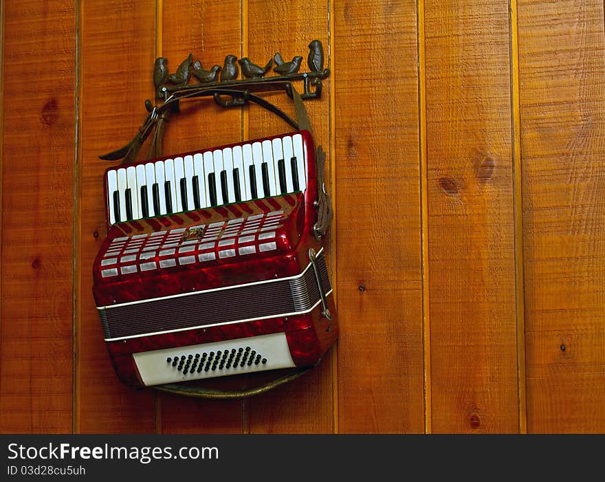 Decorative accordion on an old wooden wall. Decorative accordion on an old wooden wall