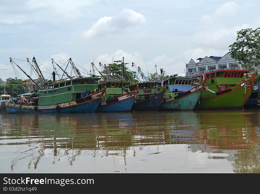 Rows of fishing boats in the river town Kuching Sarawak.