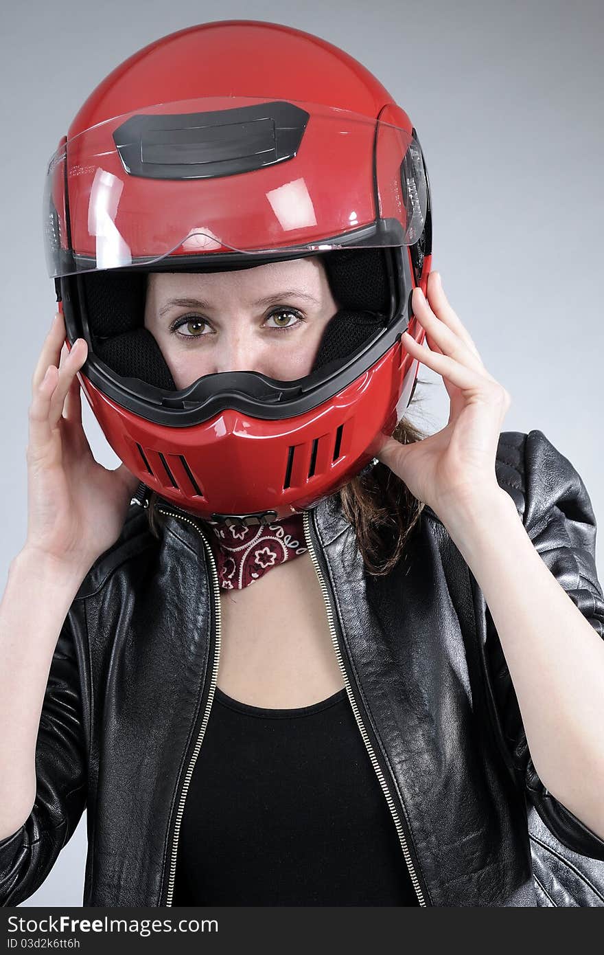 Young motorcyclist arranging helmet