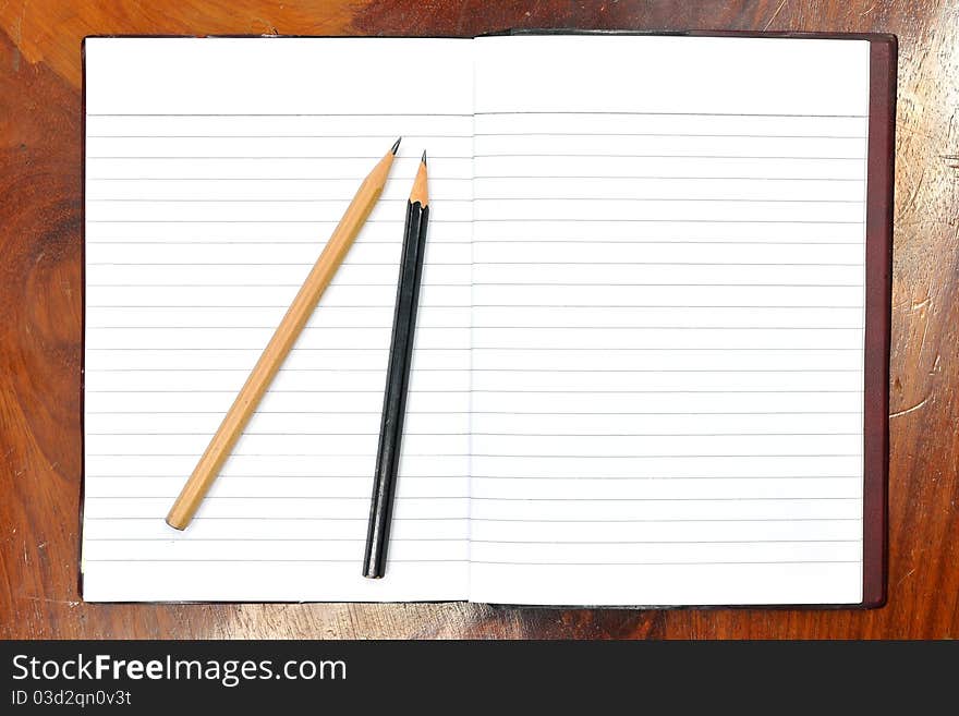 Image of Blank open notebook and pencil