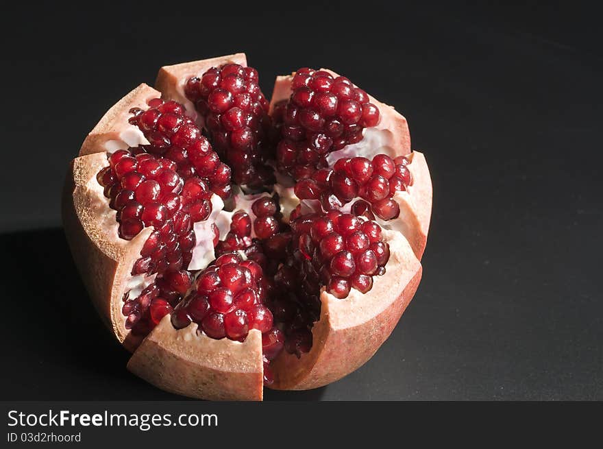 Pomegranate isolated on black background