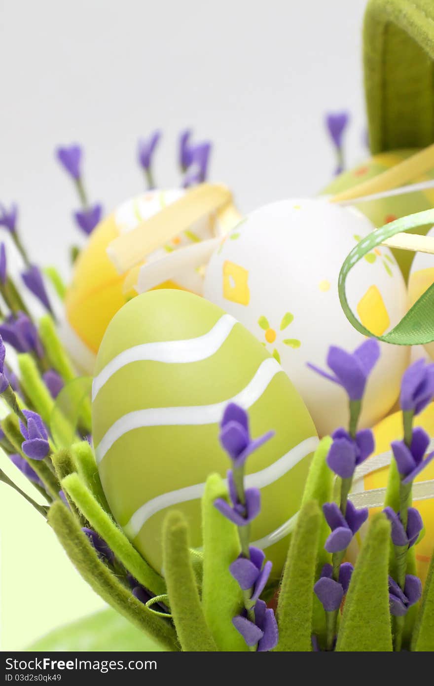 Multi-coloured eggs in a basket from a fabric from colour. Multi-coloured eggs in a basket from a fabric from colour