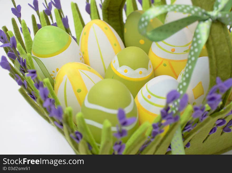 Multi-coloured eggs in a basket from a fabric from colour. Multi-coloured eggs in a basket from a fabric from colour