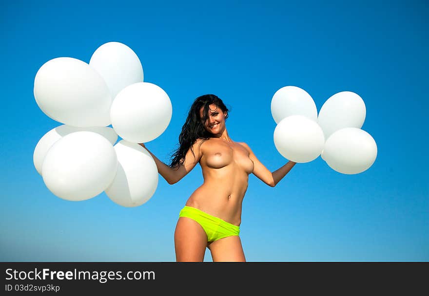 Happy girl with white balloons