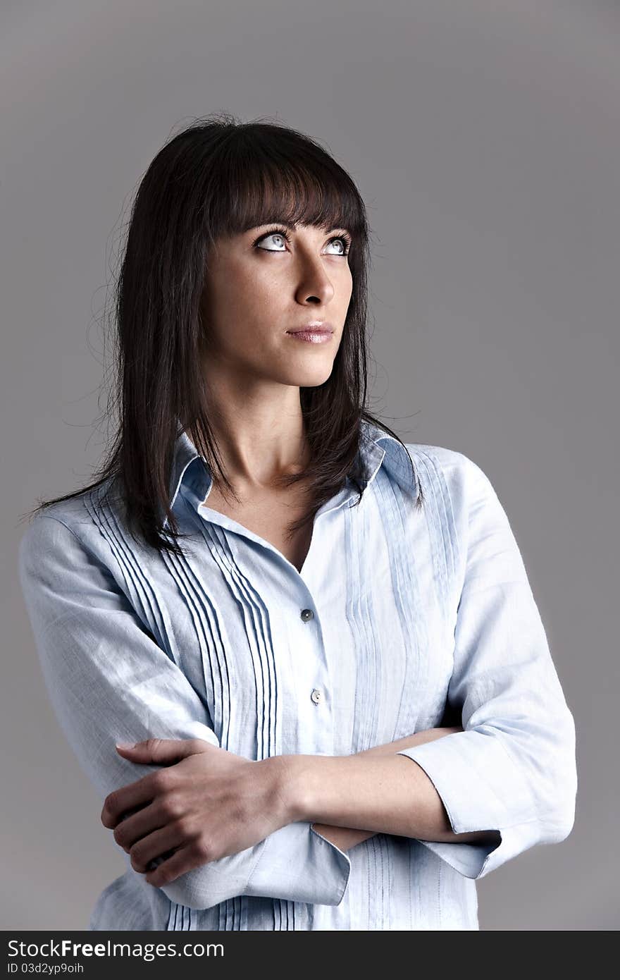 Pensive Young Woman with arms crossed