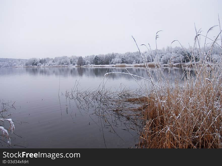 Frozen Thawing Lake In Snow Landscape