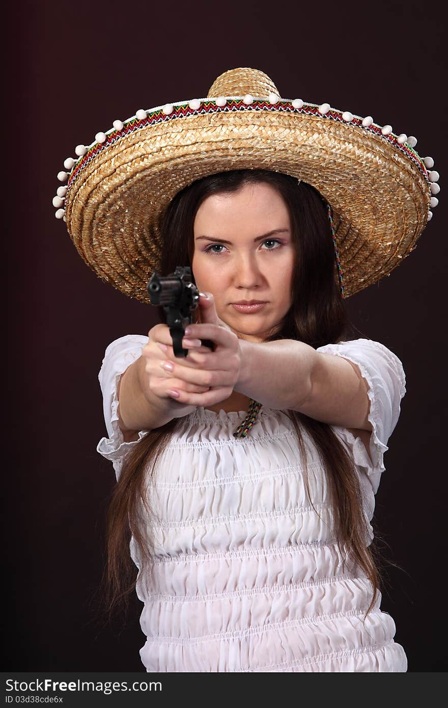 Woman in mexican costume hold revolver. Woman in mexican costume hold revolver