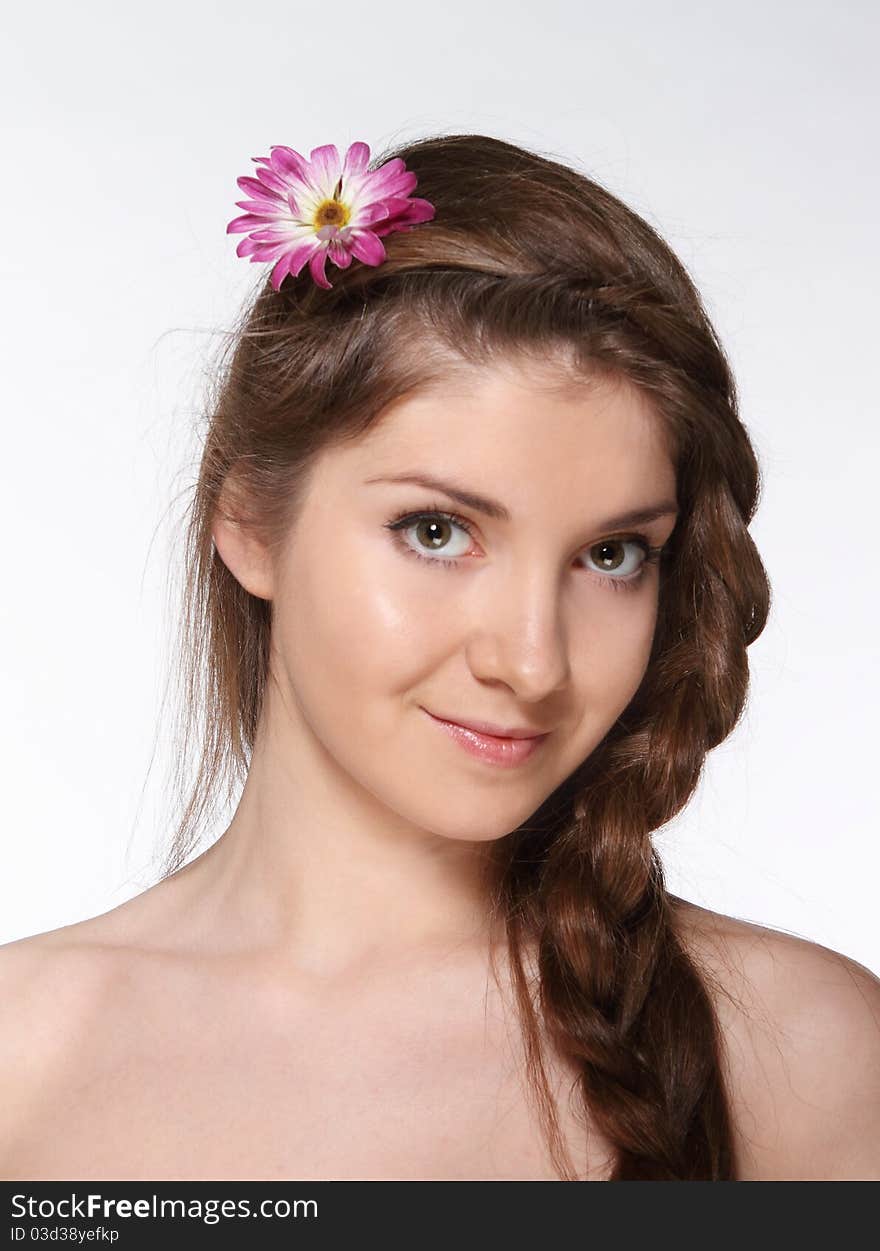 Portrait of the beauty young brunette girl with flower in her hair. Portrait of the beauty young brunette girl with flower in her hair