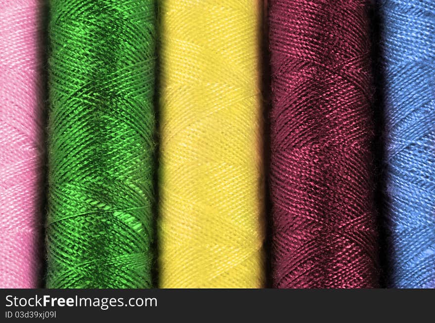 Close up on cotton thread reels of various colours. Close up on cotton thread reels of various colours