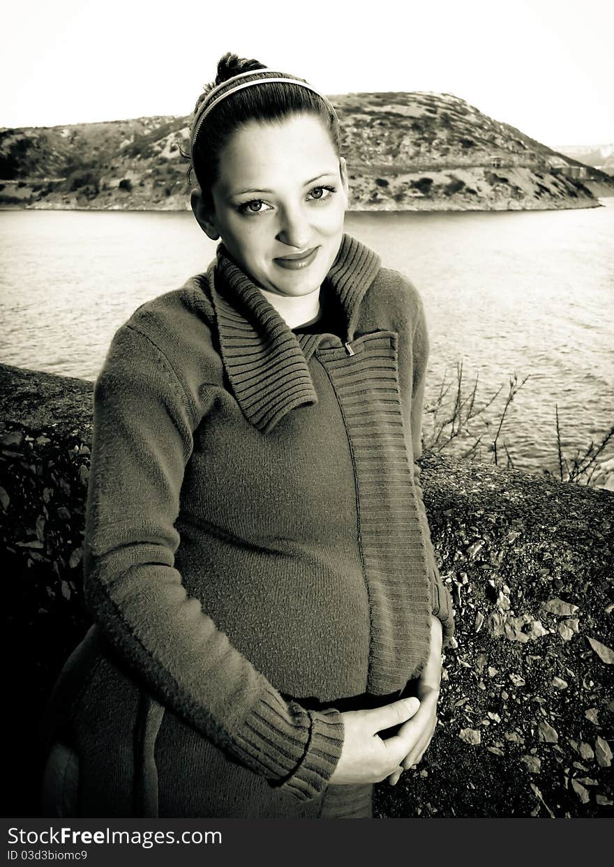 Portrait of beautiful pregnant young woman, pretty eyes and thoughtful look, holding by the wall. Portrait of beautiful pregnant young woman, pretty eyes and thoughtful look, holding by the wall