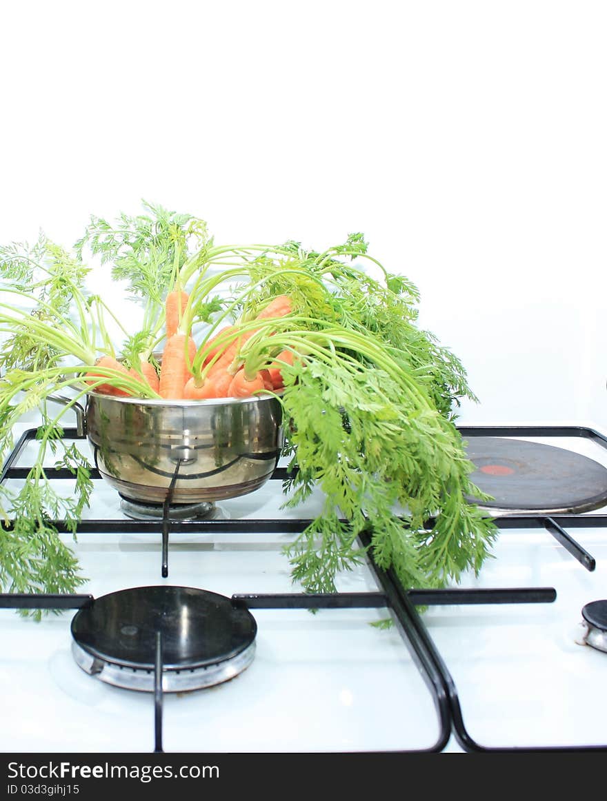 Carrots in a saucepan on the stove to gas