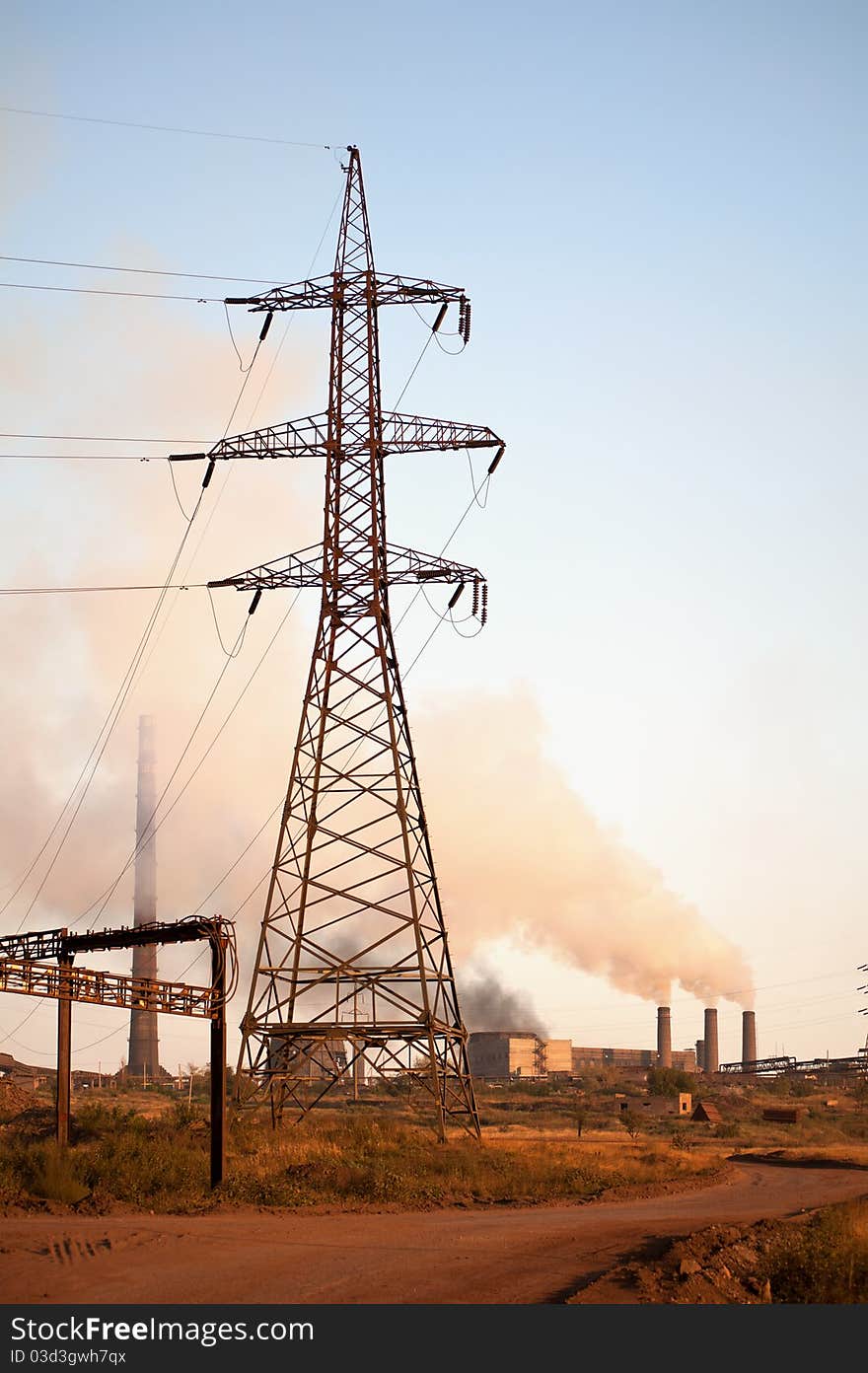 High voltage tower and old steel factory. Smoke. Industria landscape. High voltage tower and old steel factory. Smoke. Industria landscape.