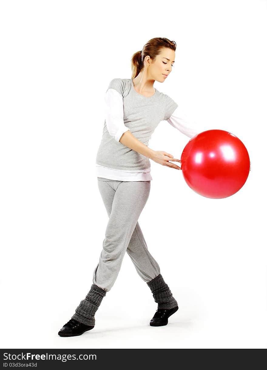 Girl exercising with a red ball, on a white background. Girl exercising with a red ball, on a white background