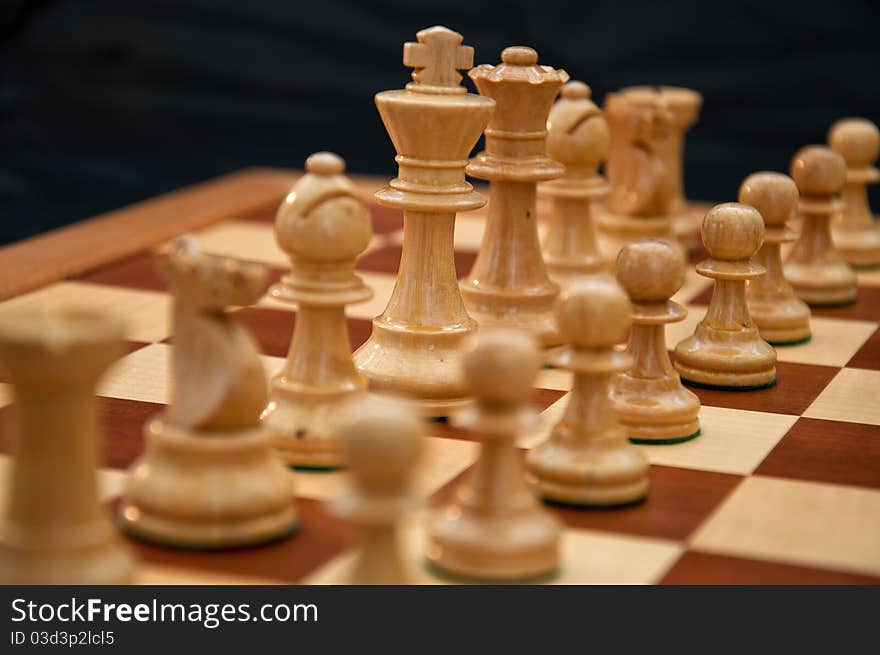 White chess pieces on chequered board. White chess pieces on chequered board