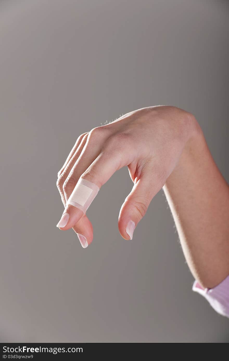 Bandage on female finger, portrait