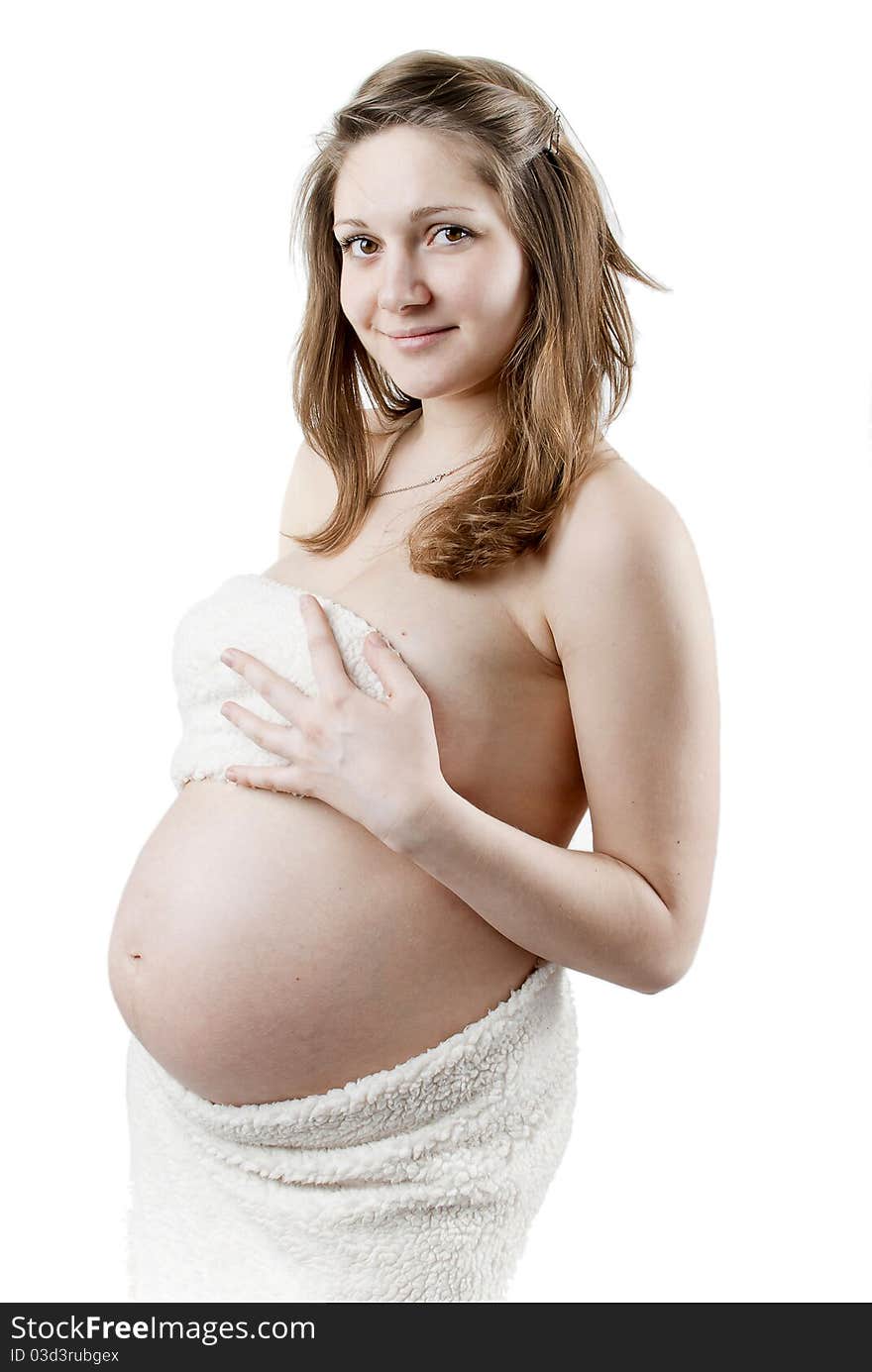 Beautiful pregnant woman in a white fur