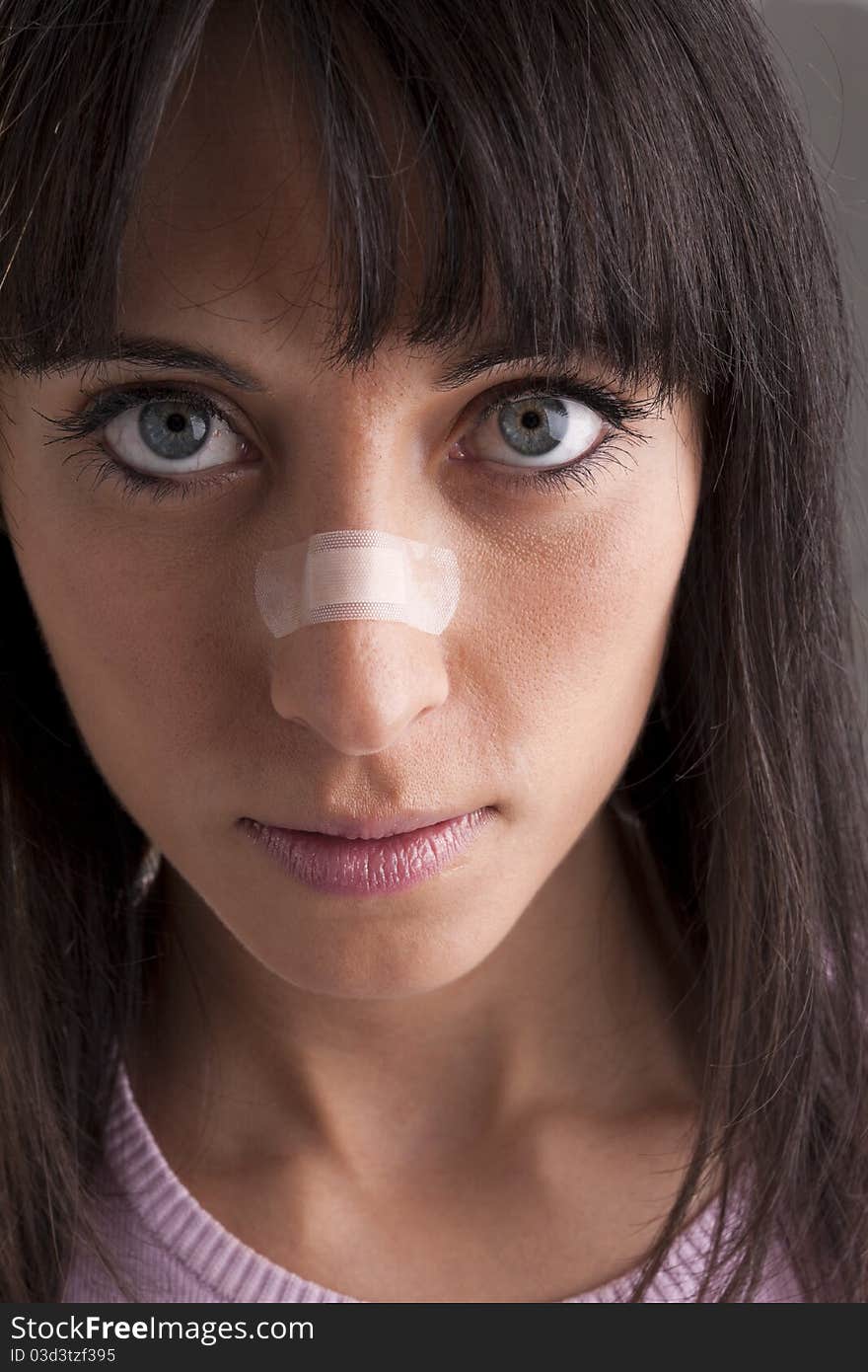 Woman with bandage on nose