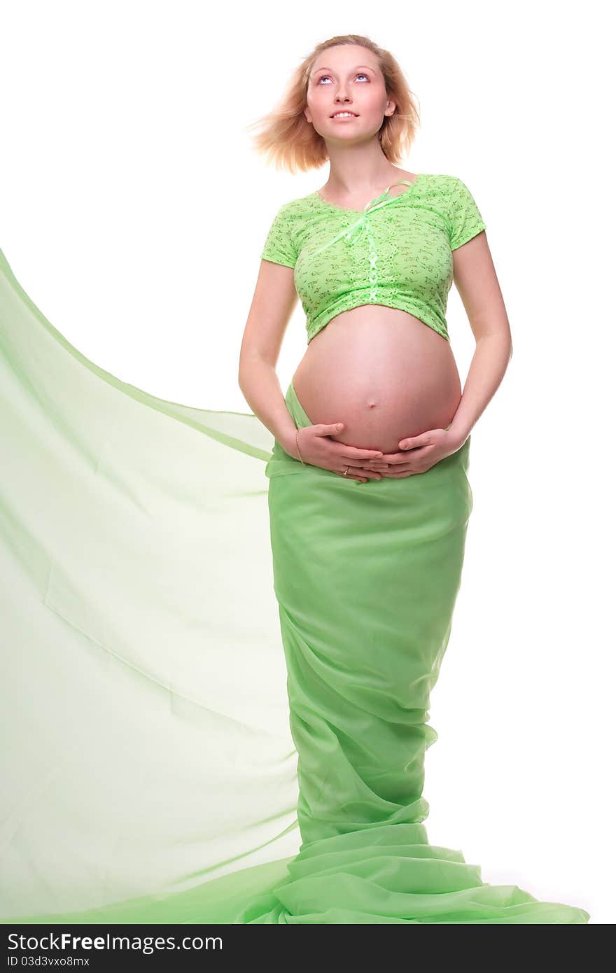 Beautiful young pregnant blonde woman with green transparent cloth in studio. Beautiful young pregnant blonde woman with green transparent cloth in studio