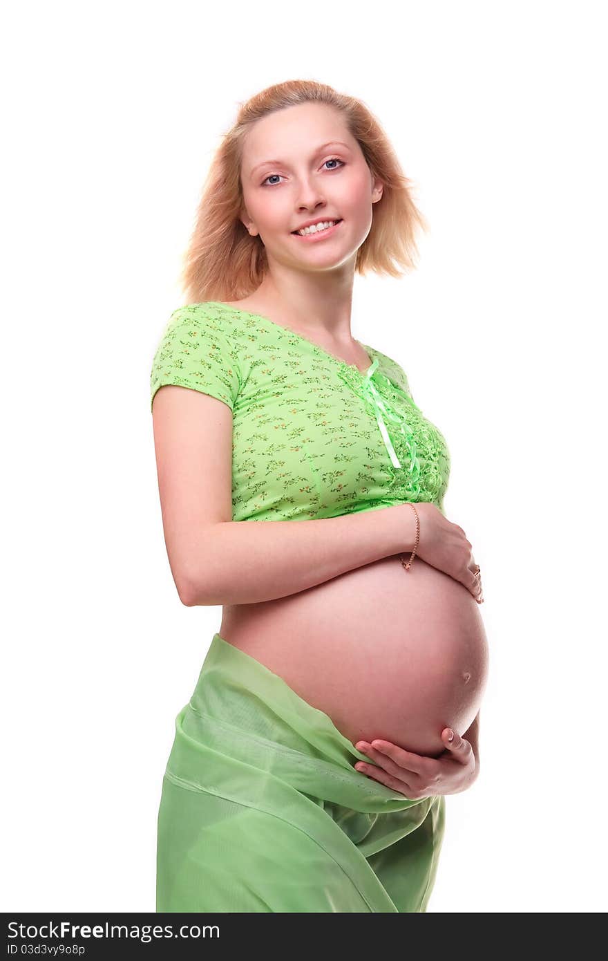 Beautiful young pregnant blonde woman with green transparent cloth in studio. Beautiful young pregnant blonde woman with green transparent cloth in studio