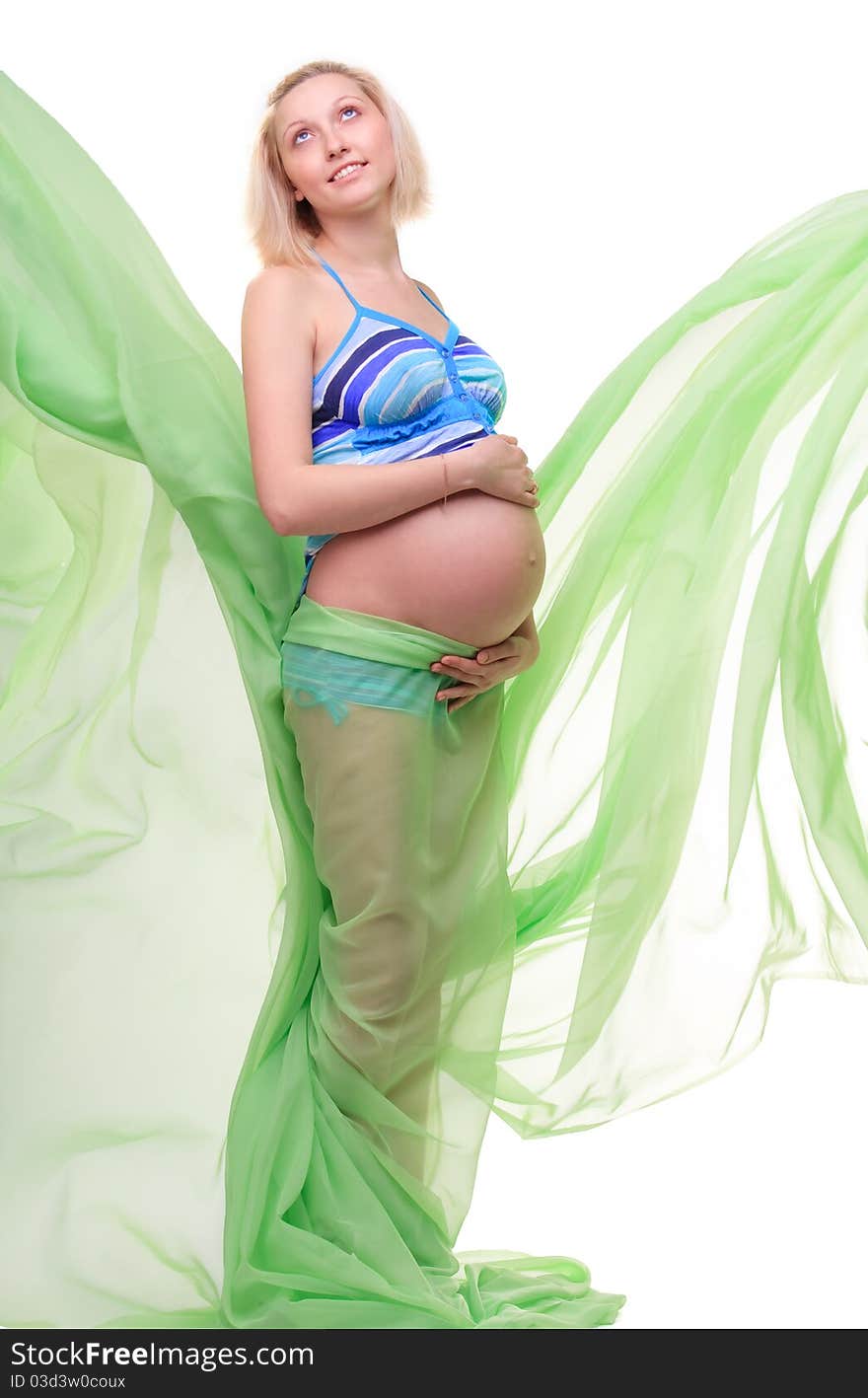 Beautiful young pregnant blonde woman with green transparent cloth in studio. Beautiful young pregnant blonde woman with green transparent cloth in studio