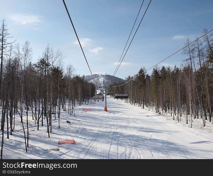 Ski lift on the slope of a forested