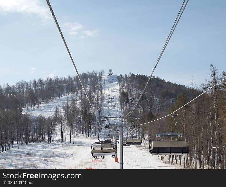 Ski lift on the slope of a forested. Ski lift on the slope of a forested