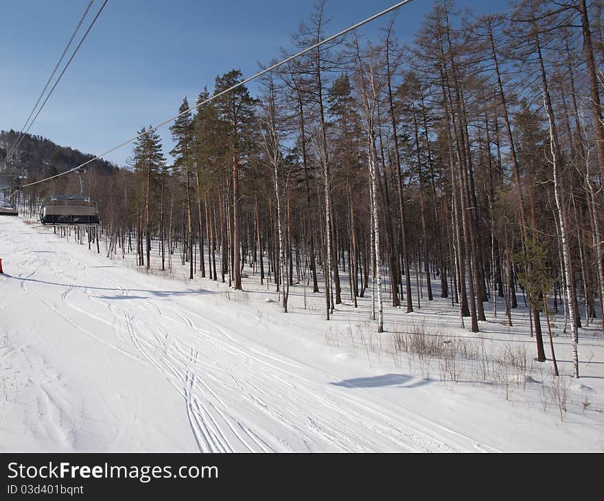 Ski lift on the slope of a forested. Ski lift on the slope of a forested