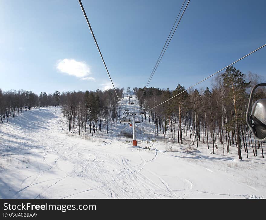 Ski lift on the slope of a forested. Ski lift on the slope of a forested