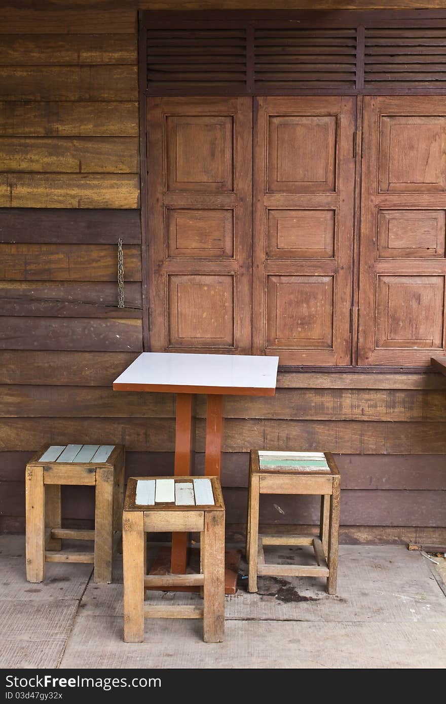 Wooden tables and chairs near the old window