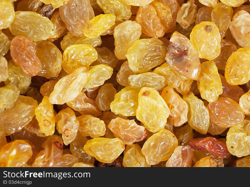 Golden yellow raisins background