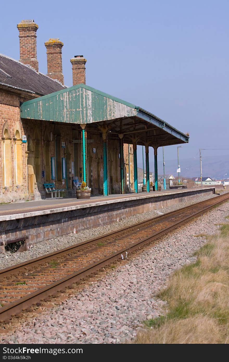 The platform and railway line at a desrted rural railway station. The platform and railway line at a desrted rural railway station