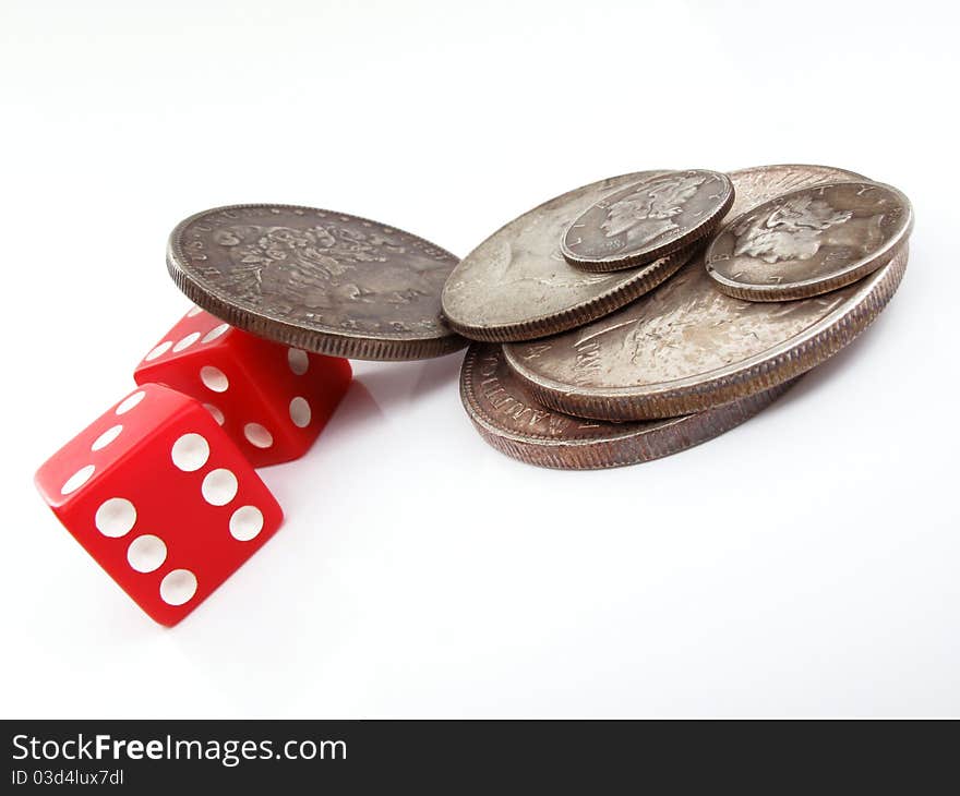 Silver coins and red dice. Silver coins and red dice