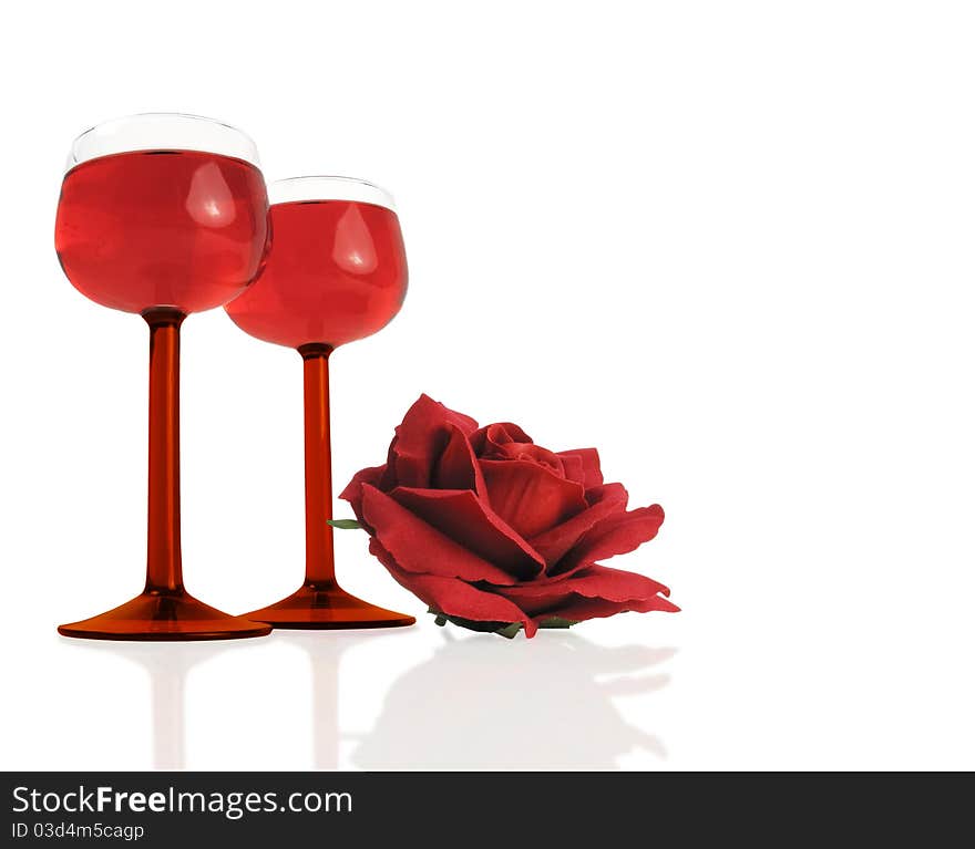 Beautiful wine glasses with a red silk rose on white. Beautiful wine glasses with a red silk rose on white