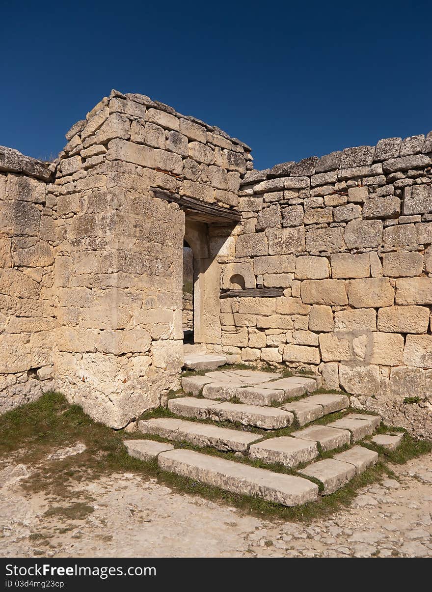 Steps and door to the ancient stone wall