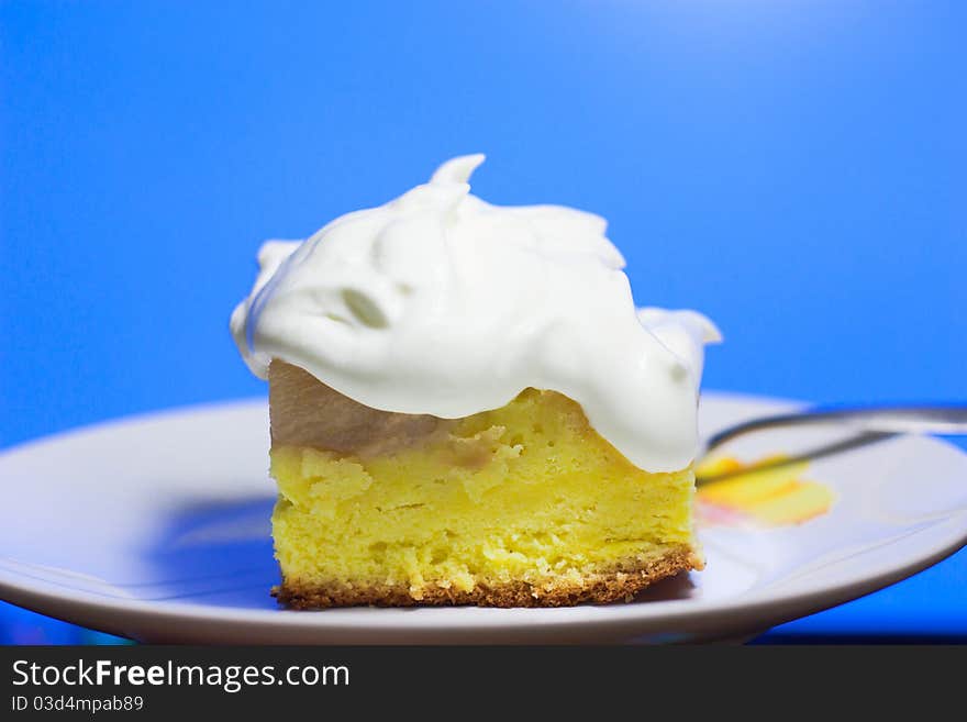 Closeup of a piece of cake on blue background. Closeup of a piece of cake on blue background