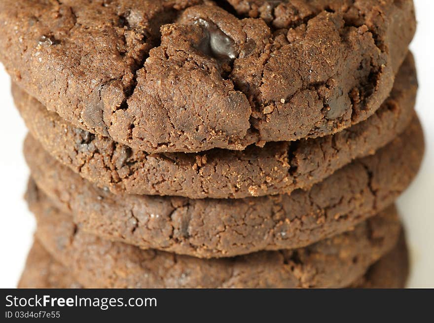 Stack of chocolate cookies on white background