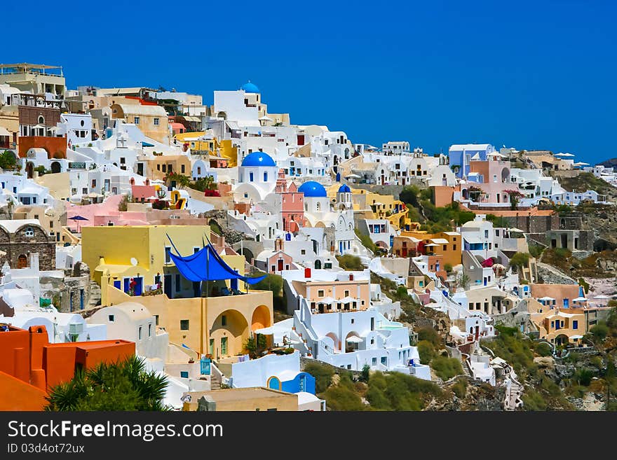 Classic view of Oia on island of Santorini in Greece. Traditional architecture with famous blue belfries. Classic view of Oia on island of Santorini in Greece. Traditional architecture with famous blue belfries.