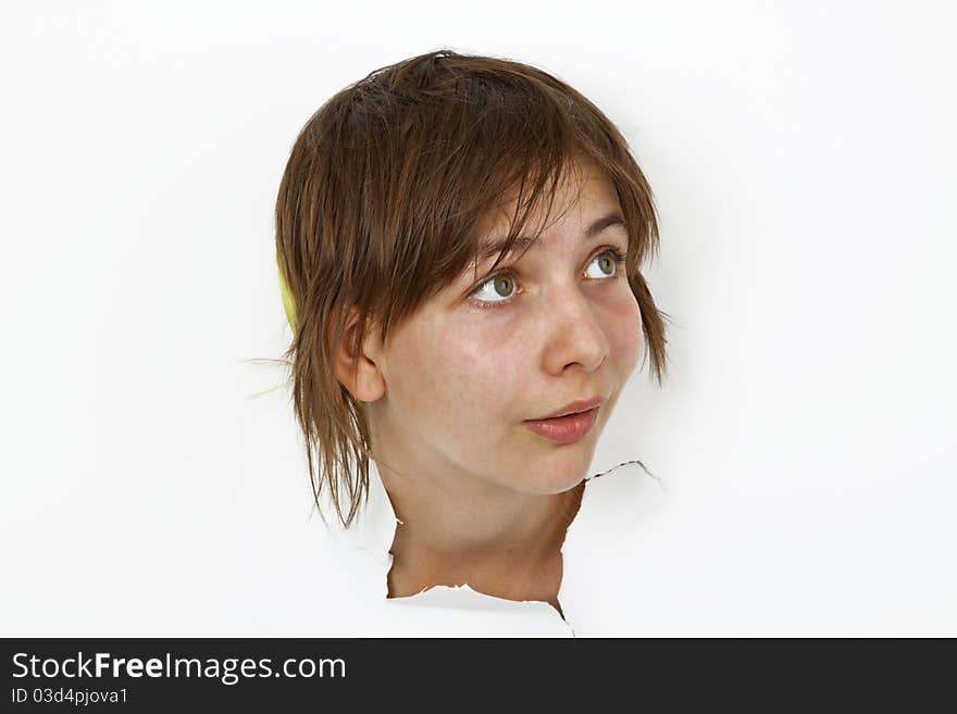 Young Woman is looking out of cutted paper.