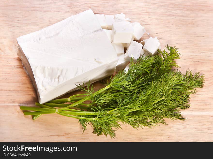 Cheese and fresh dill on the cutting board