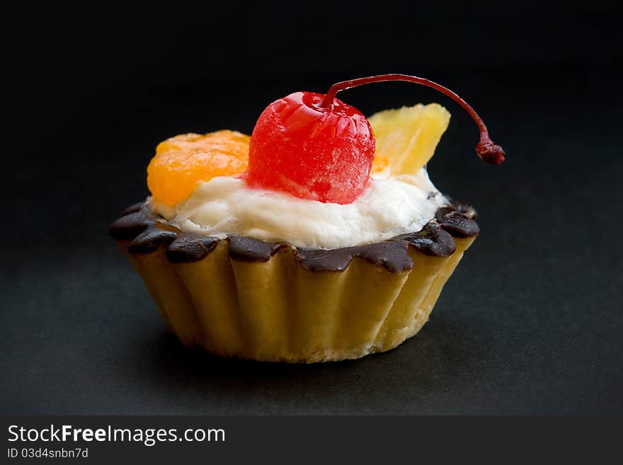 Chocolate covered baking with fruits - cherry, orange and grapefruit. Chocolate covered baking with fruits - cherry, orange and grapefruit